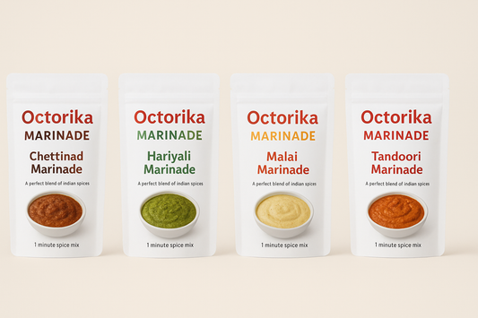 A digital photograph displaying four Octorika marinade packs โ Chettinad marinade, Hariyali marinade, Malai marinade, and Tandoori marinade โ arranged in a row against a clean background