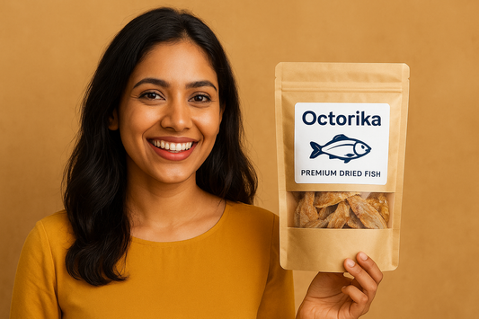 A smiling South Asian woman in a red outfit holding a packet of Octorika Premium Dried Fish against a red background, showcasing the brandโs seafood product