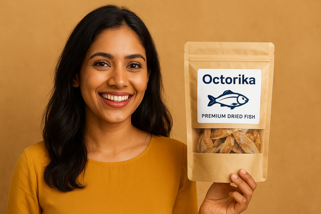 A smiling South Asian woman in a red outfit holding a packet of Octorika Premium Dried Fish against a red background, showcasing the brand’s seafood product