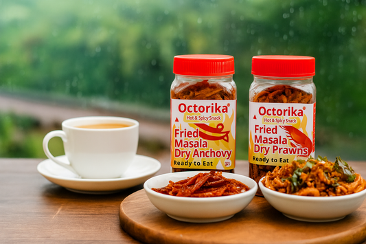 A cozy tea-time setup with a cup of tea on a wooden table, accompanied by Octorika’s Fried Masala Dry Anchovy and Fried Masala Dry Prawns jars, with a soothing rainy background creating a homely and inviting atmosphere