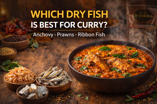 Steaming bowl of spicy dry fish curry served in a black bowl, garnished with fresh coriander leaves, surrounded by small bowls of dry anchovy, dry prawns, and ribbon fish on a rustic wooden table