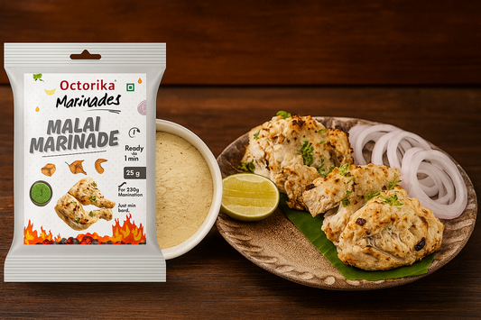Octorika Malai Marinade with a packet of the marinade mix, a bowl of creamy marinade powder, and a plate of grilled malai tikka garnished with coriander, onion rings, and a lemon slice, set against a rustic wooden kitchen background 